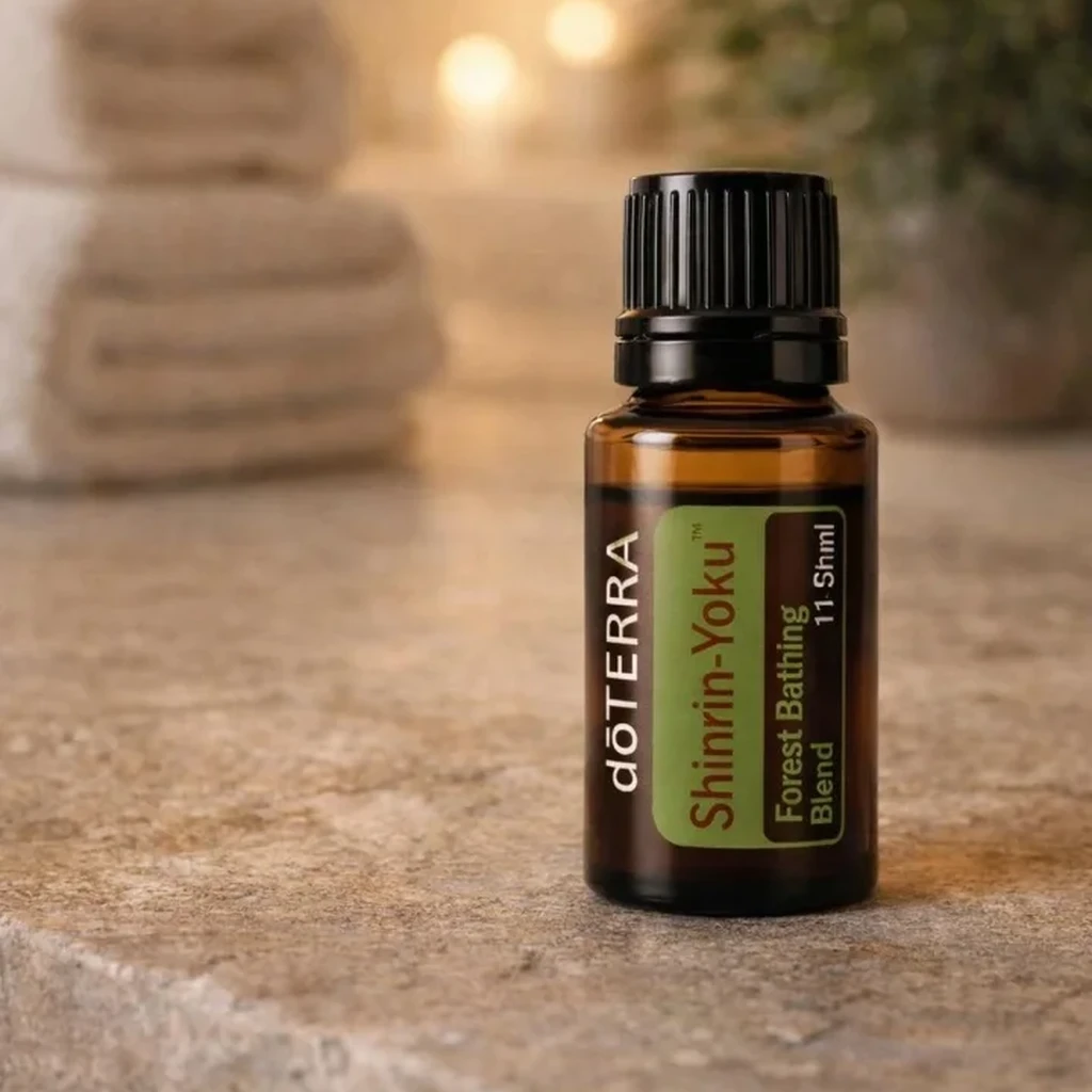 Shinrin-yoku doTERRA na kamiennej podstawce obok złożonych ręczników spa