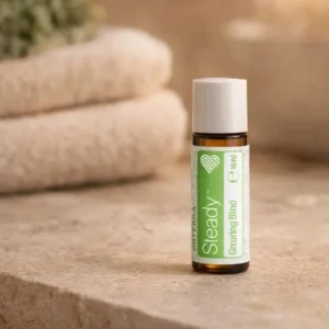 Steady doTERRA na kamiennej podstawce obok złożonych ręczników spa