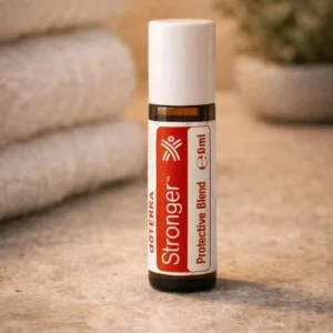 Stronger doTERRA na kamiennej podstawce obok złożonych ręczników spa