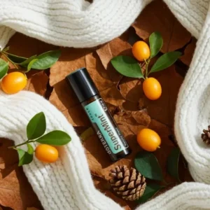 Supermint Touch doTERRA na jesiennej dekoracji z liśćmi i szyszkami