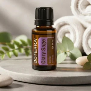 Szałwia Muszkatołowa doTERRA na kamiennej podstawce obok złożonych ręczników spa