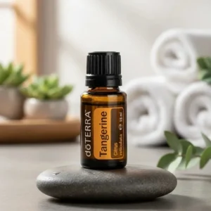 Tangerynka doTERRA na kamiennej podstawce obok złożonych ręczników spa