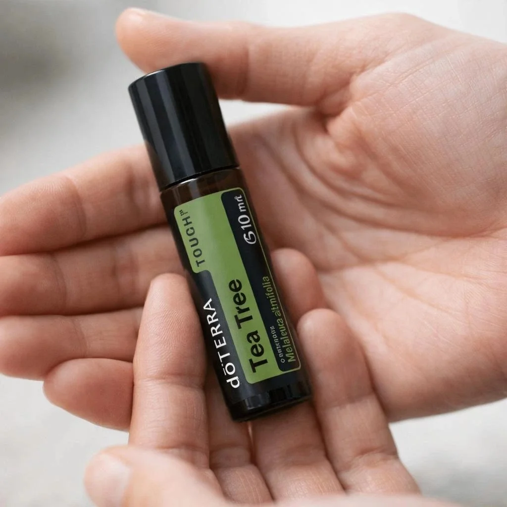 Dłonie trzymające Tea Tree Touch doTERRA – aplikacja olejku