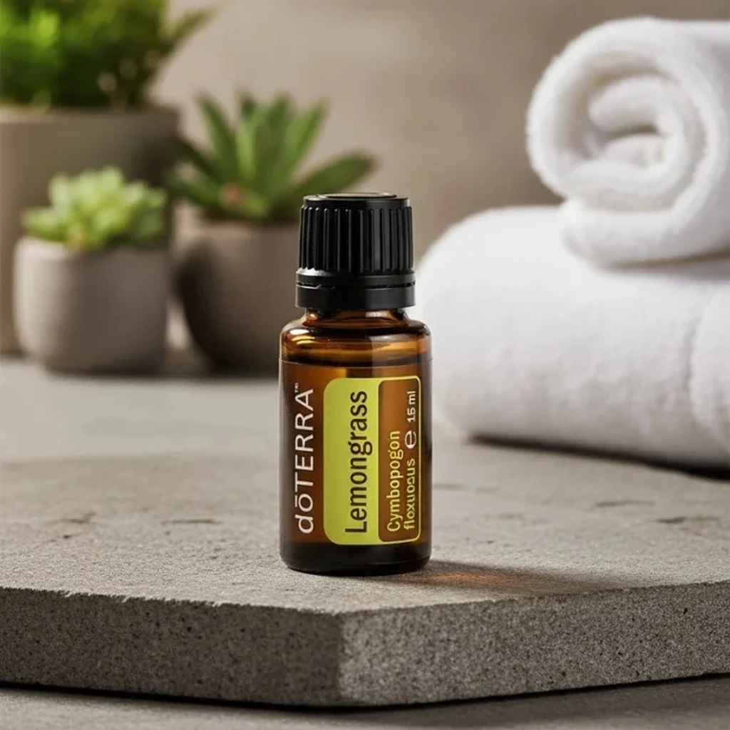 Trawa Cytrynowa doTERRA na kamiennej podstawce obok złożonych ręczników spa