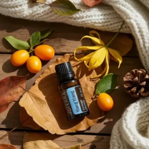 Ylang Ylang doTERRA na jesiennej dekoracji z liśćmi i szyszkami