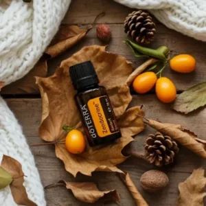 Zendocrine doTERRA na jesiennej dekoracji z liśćmi i szyszkami
