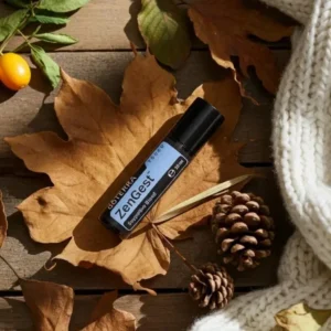 Zengest Touch doTERRA na jesiennej dekoracji z liśćmi i szyszkami