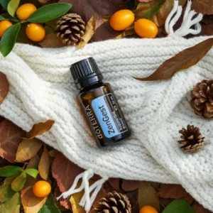 Zengest doTERRA na jesiennej dekoracji z liśćmi i szyszkami