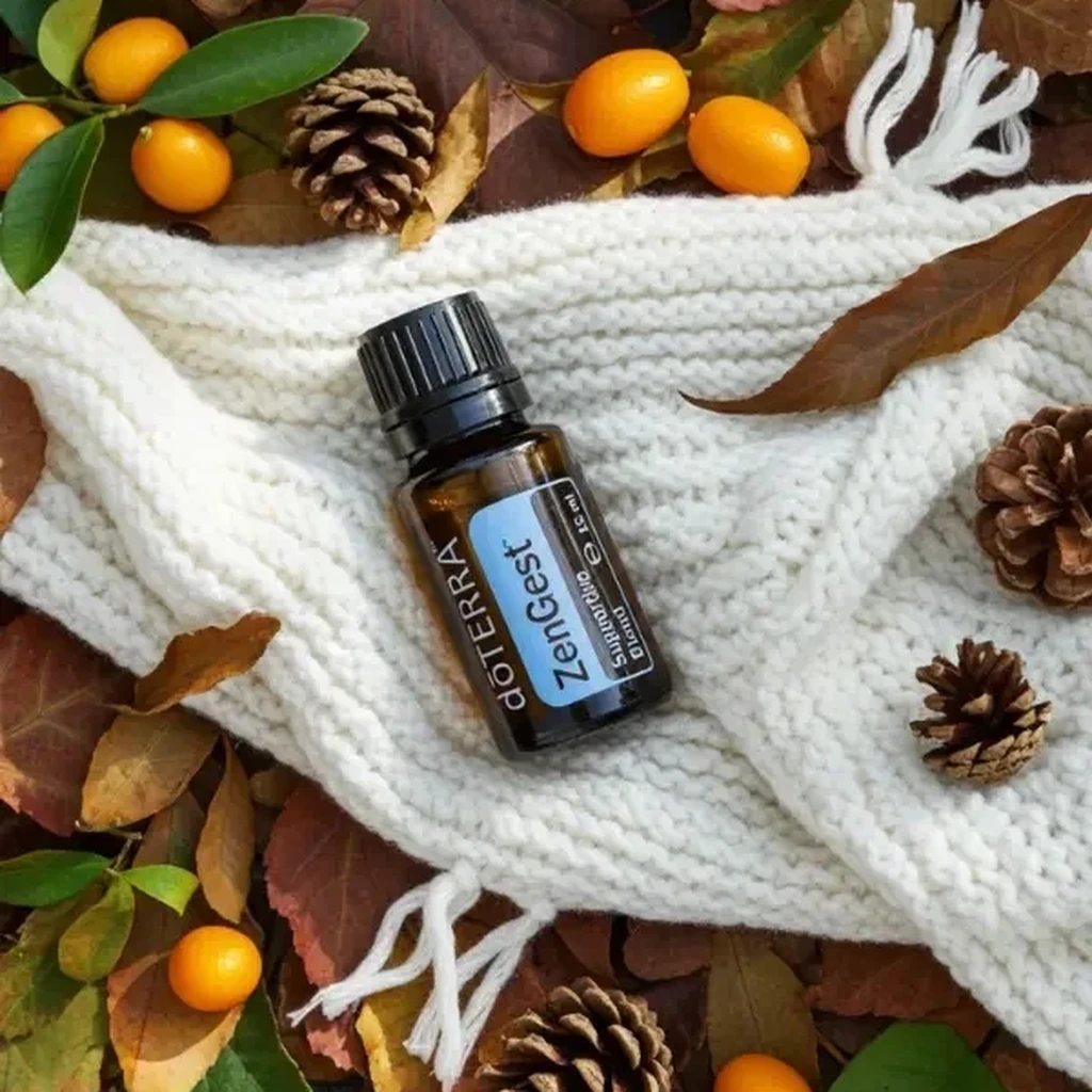 Zengest doTERRA na jesiennej dekoracji z liśćmi i szyszkami