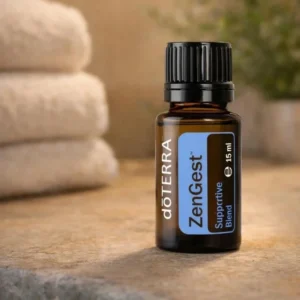 Zengest doTERRA na kamiennej podstawce obok złożonych ręczników spa